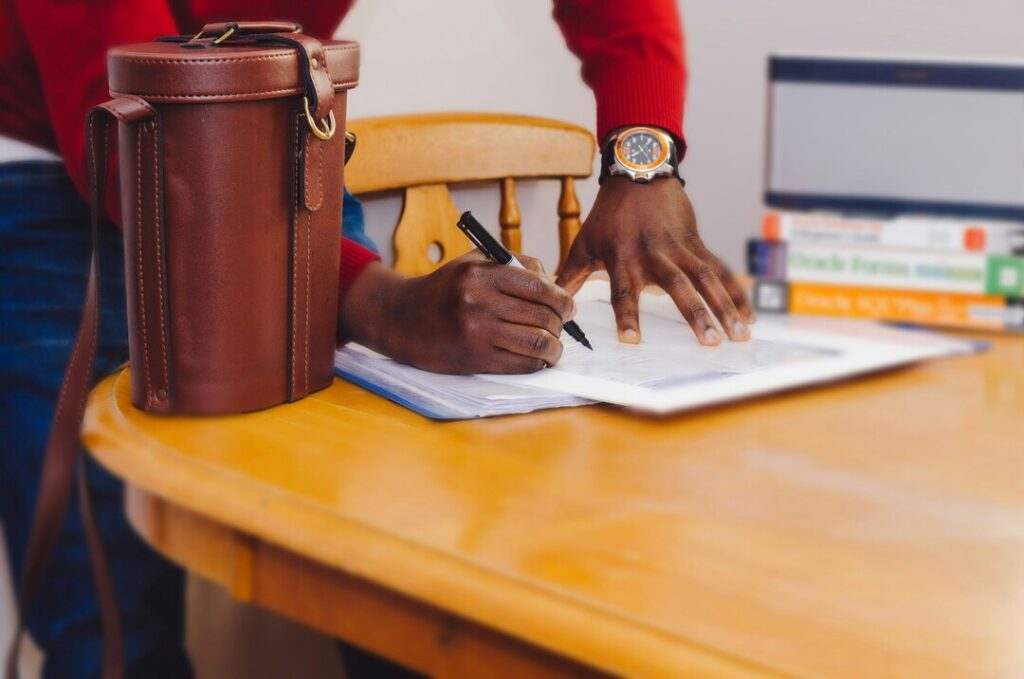 A person signing a contract.